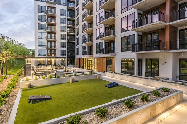 Patio at LakeHaus Apartments in Minneapolis featuring modern furniture and lake views, located at 3100 W Lake St