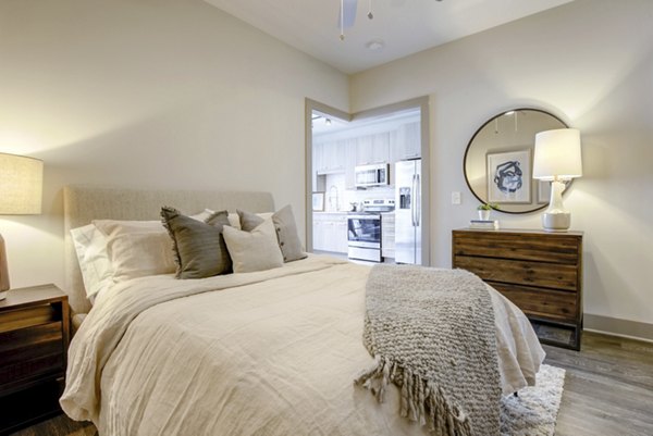 Cozy bedroom with modern furnishings and natural light at The Dillon Apartments