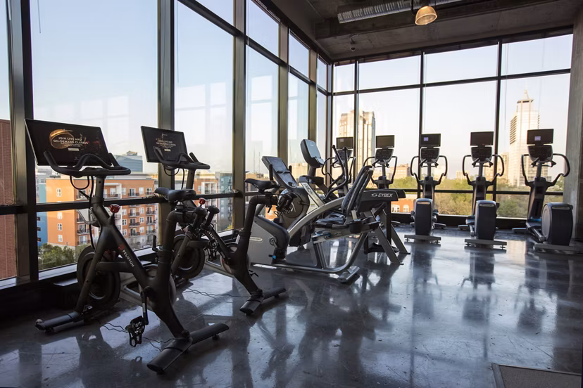 The Dillon: Spacious gym with modern fitness equipment in Kane Residential apartments