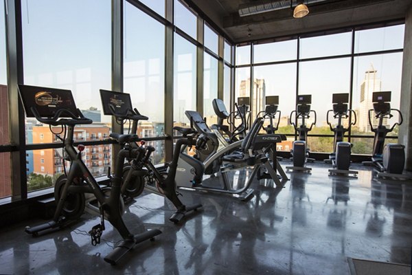 The Dillon: Spacious gym with modern fitness equipment in Kane Residential apartments