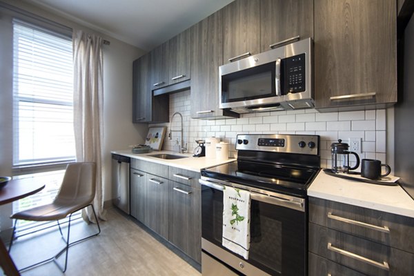 Kitchen featuring stainless steel appliances and modern cabinetry in The Dillon