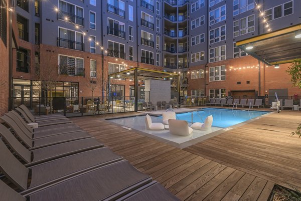 Poolside relaxation area with lounge chairs at The Dillon Apartments