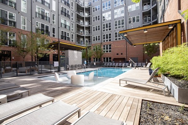 Rooftop pool with loungers at The Dillon Apartments offering luxury living experience