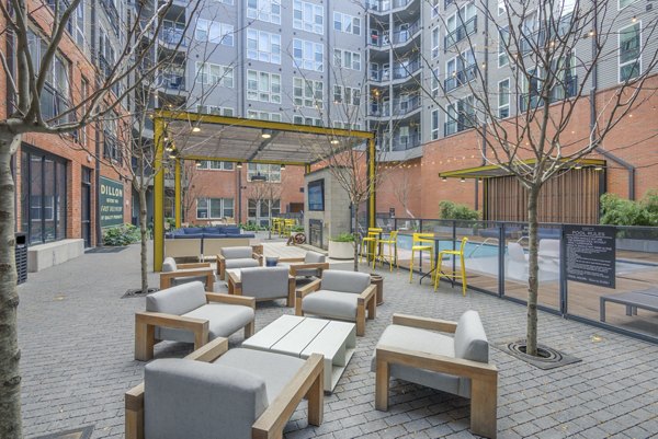 Courtyard with lush landscaping and seating areas at The Dillon Apartments