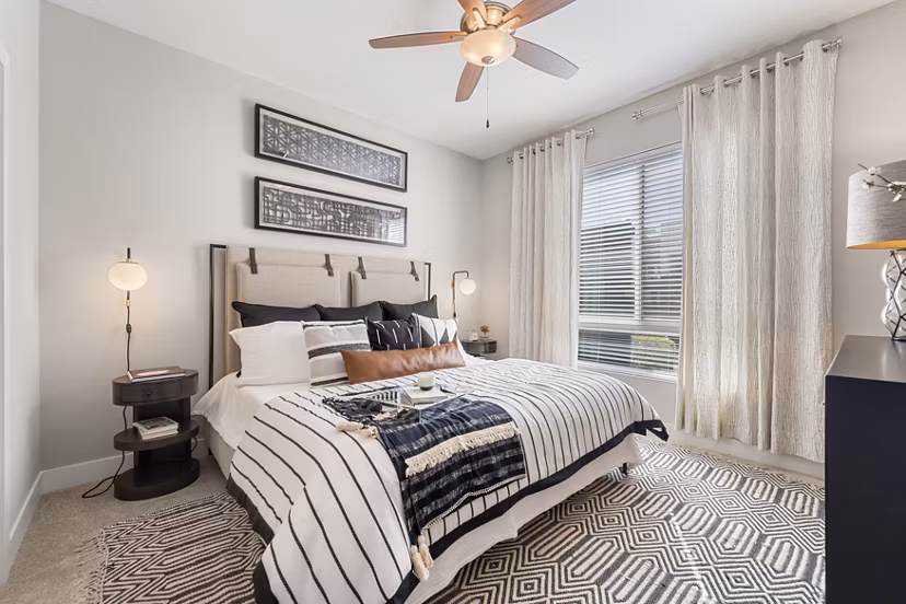 Spacious bedroom with modern furnishings at Maxwell on 66th Apartments in luxury community