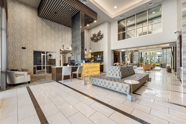 Inviting clubhouse with modern design at Maxwell on 66th Apartments, offering luxury social spaces and community amenities