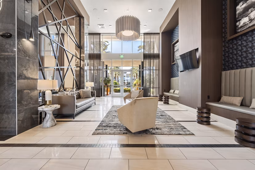 Clubhouse featuring modern decor and communal seating at Maxwell on 66th Apartments