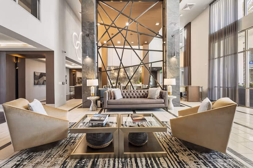Maxwell on 66th Apartments: Modern clubhouse featuring lounge seating and a fireplace