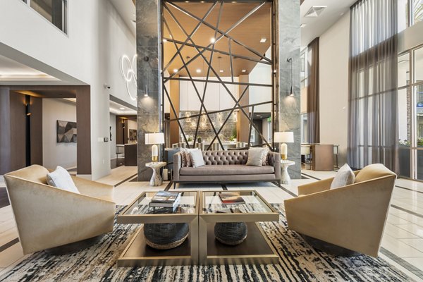 Maxwell on 66th Apartments: Modern clubhouse featuring lounge seating and a fireplace