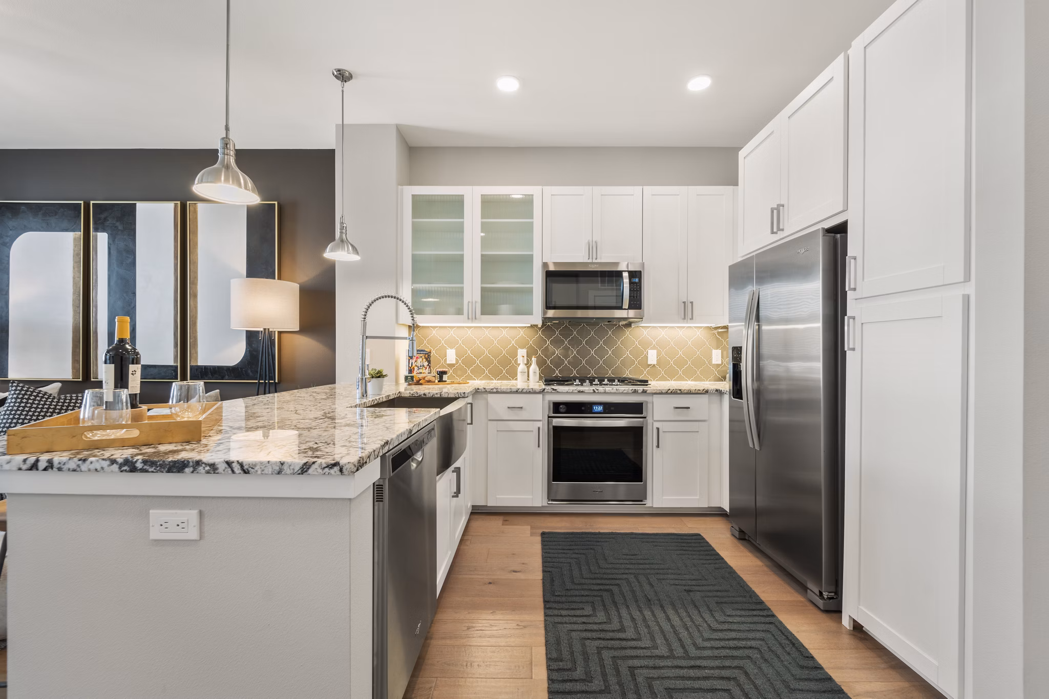Kitchen with granite countertops and stainless steel appliances at Maxwell on 66th luxury apartments