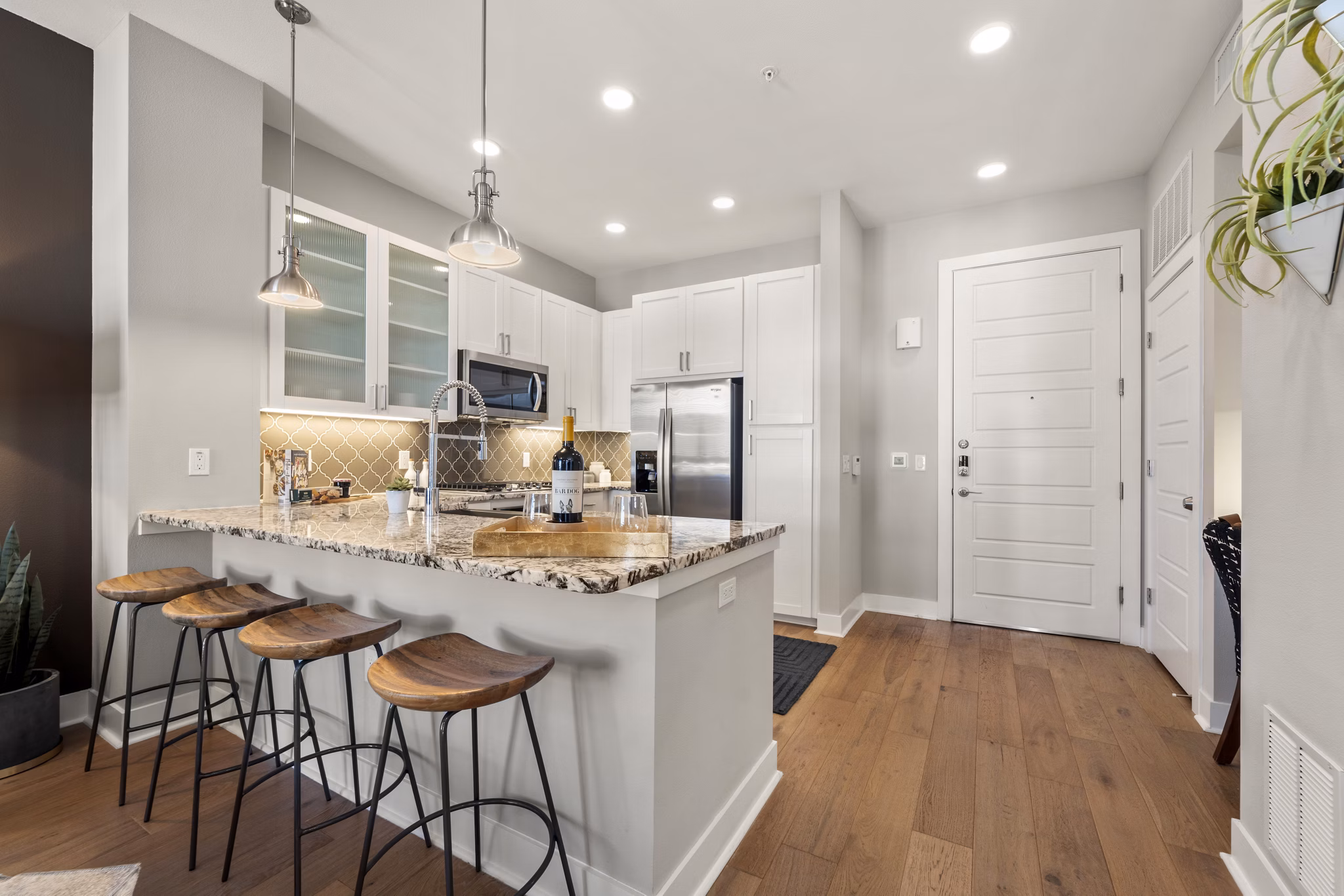 Modern kitchen with stainless steel appliances at Maxwell on 66th Apartments, luxury living spaces by Greystar