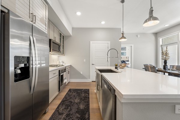 Maxwell on 66th Apartments: Modern kitchen with stainless steel appliances and sleek countertops, ideal for luxury living