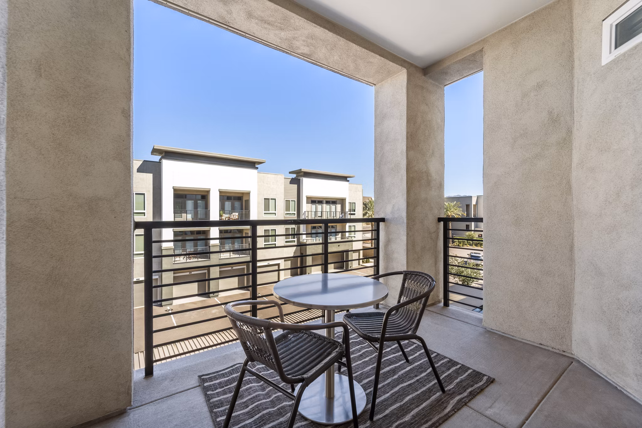 Balcony with seating and city views at Maxwell on 66th Apartments