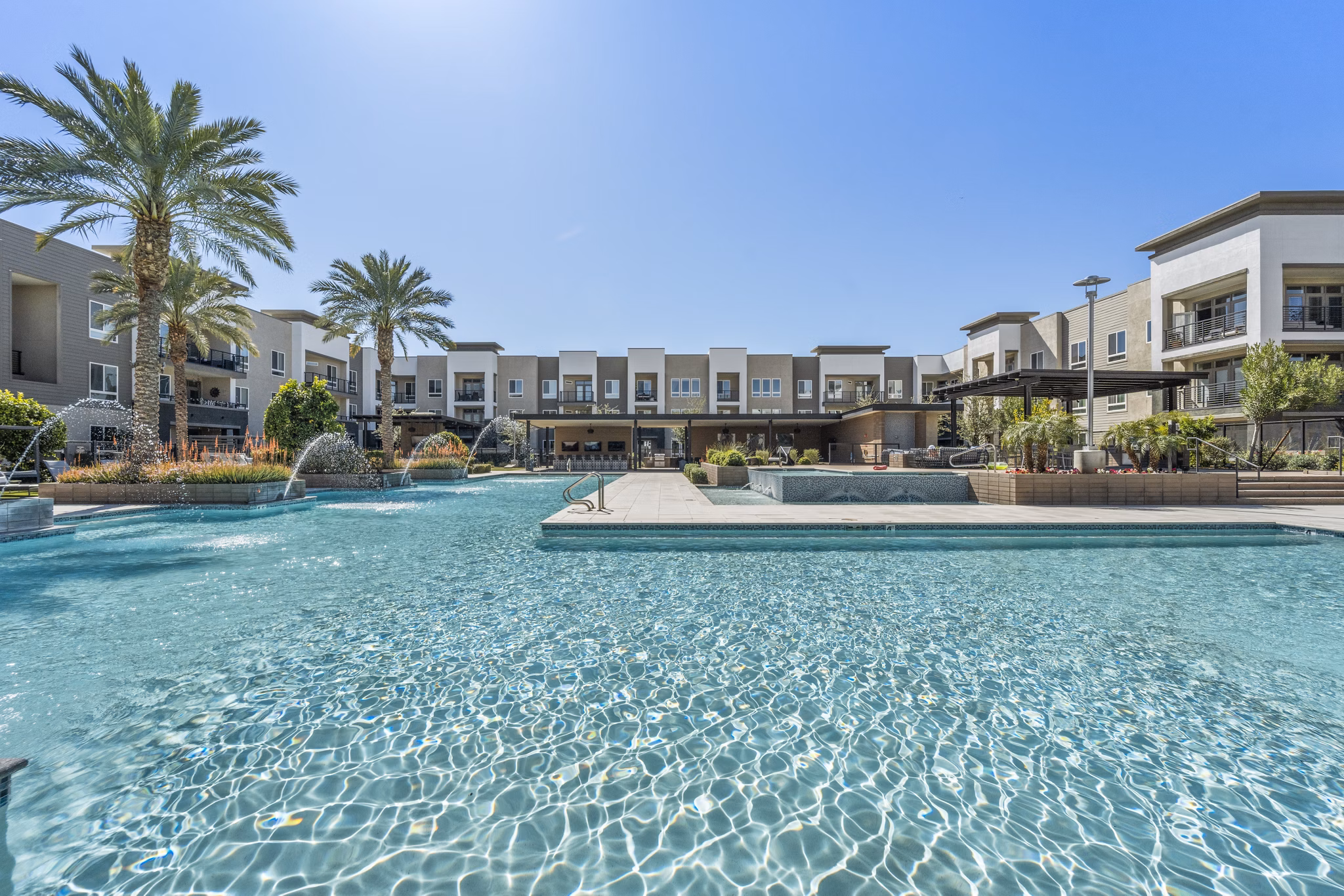 Infinity pool with loungers at Maxwell on 66th Apartments