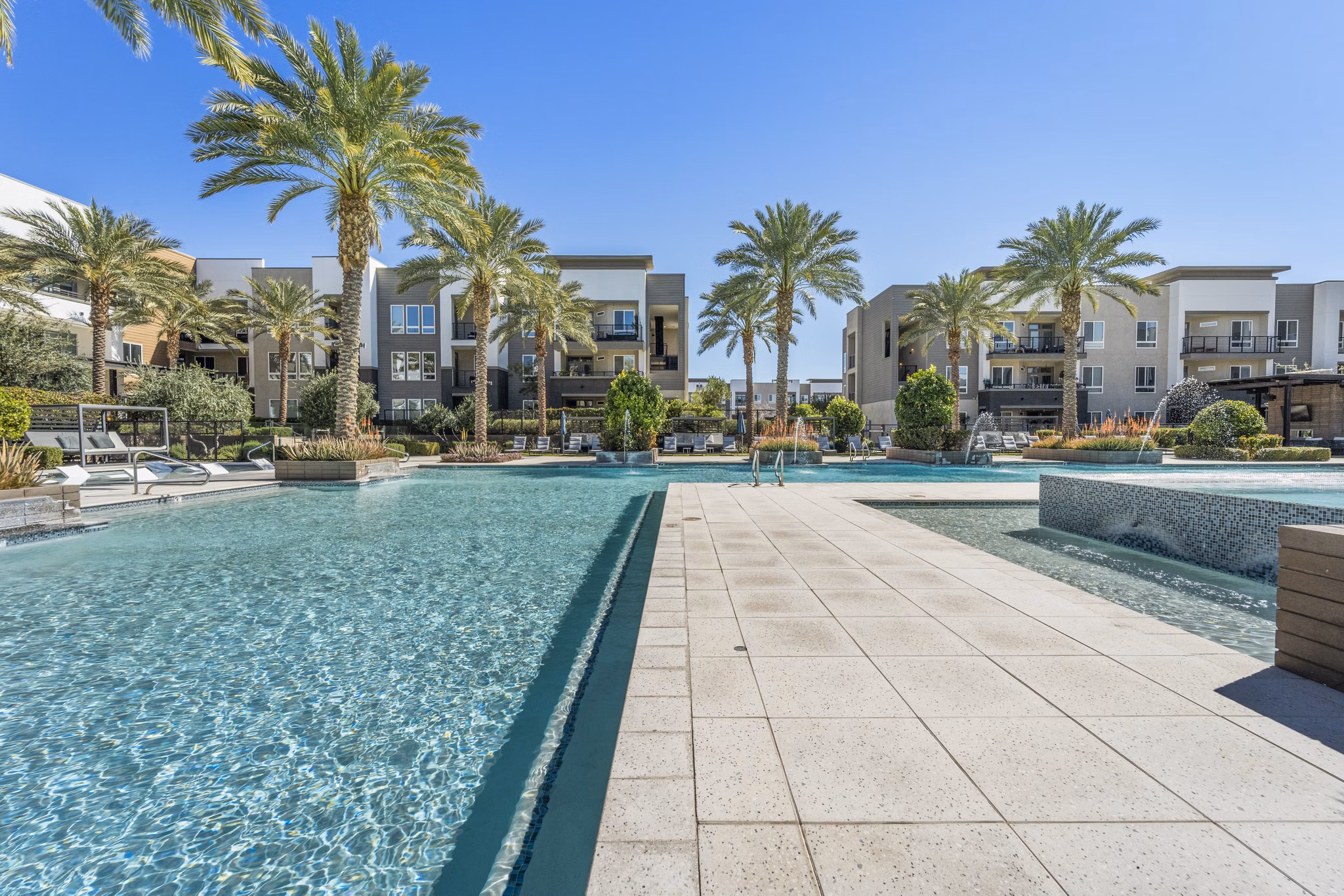 Outdoor pool with lounge chairs at Maxwell on 66th Apartments