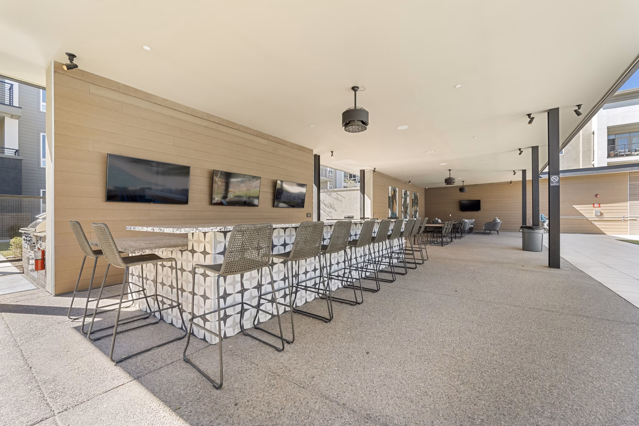 Grill area with modern outdoor seating at Maxwell on 66th Apartments, luxury residence in a vibrant neighborhood