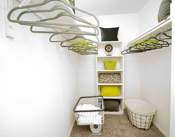 Walk-in closet with customizable shelving at 3 Corners East Apartments