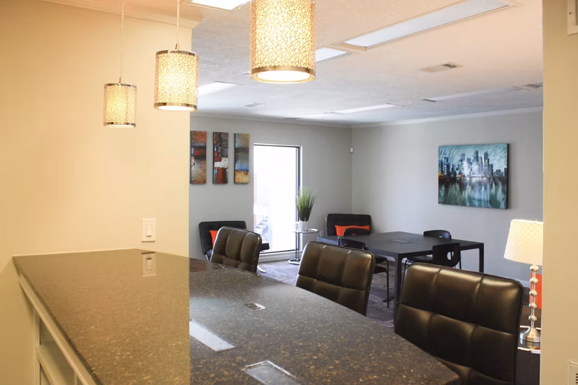 Clubhouse with modern decor and ample seating at 3 Corners East Apartments, featuring social areas and entertainment options