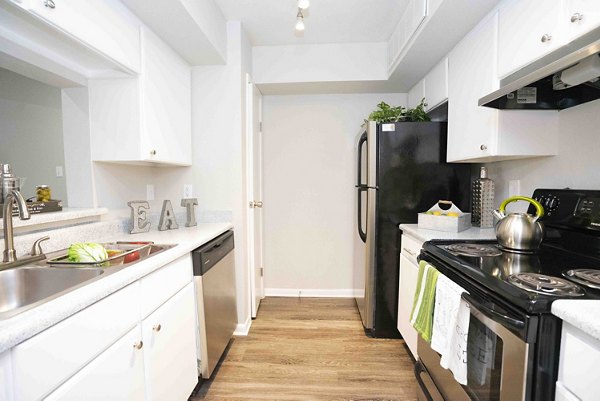 Kitchens featuring granite countertops and stainless steel appliances in 3 Corners East Apartments