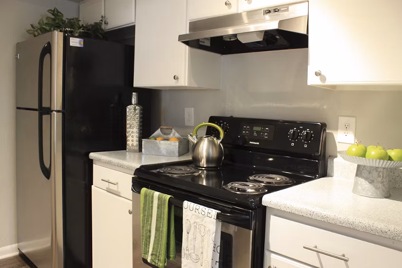 Modern kitchen with stainless steel appliances at 3 Corners East Apartments
