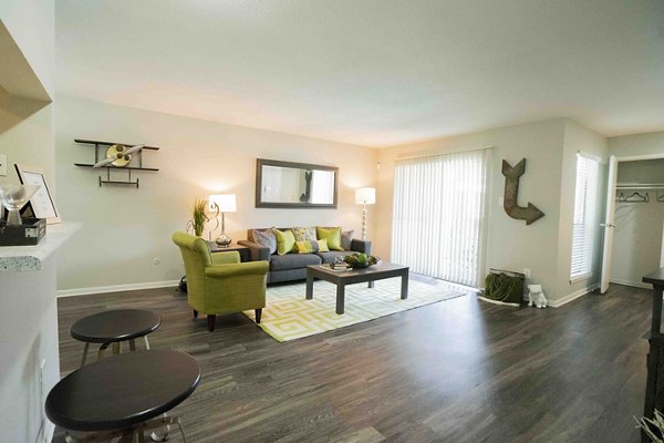 Spacious living room with modern decor and large windows at 3 Corners East Apartments, offering luxurious comfort