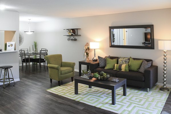 Bright living room with modern furnishings at 3 Corners East Apartments, ideal for urban lifestyles in booming neighborhoods