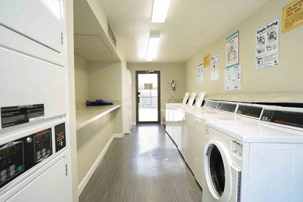 Laundry room with modern appliances at 3 Corners East Apartments