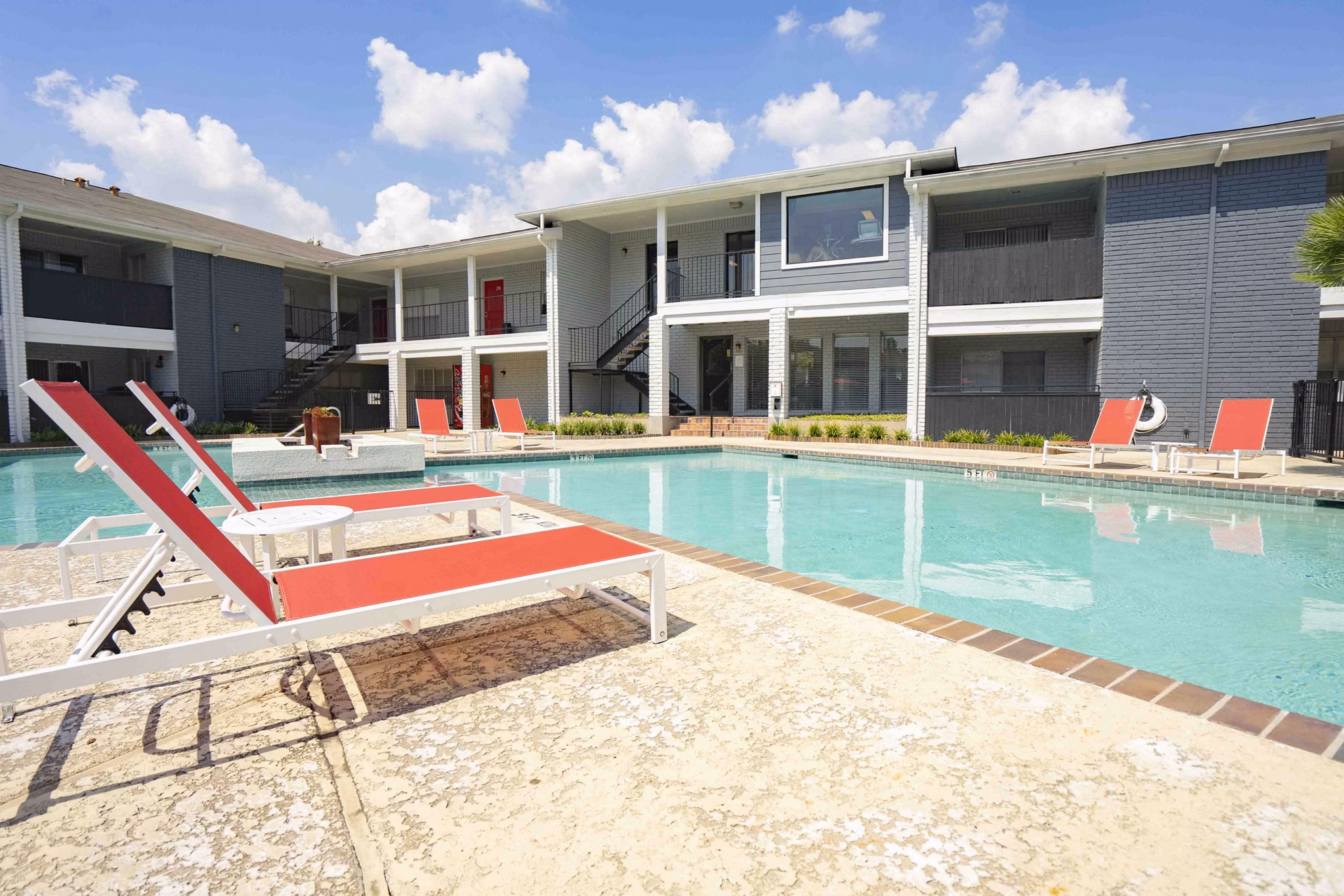 Rooftop pool with lounging areas at 3 Corners East Apartments, ideal for relaxation and leisure activities