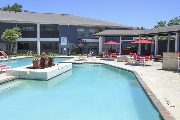 Relaxing outdoor pool area at 3 Corners East Apartments offering a tranquil oasis for residents