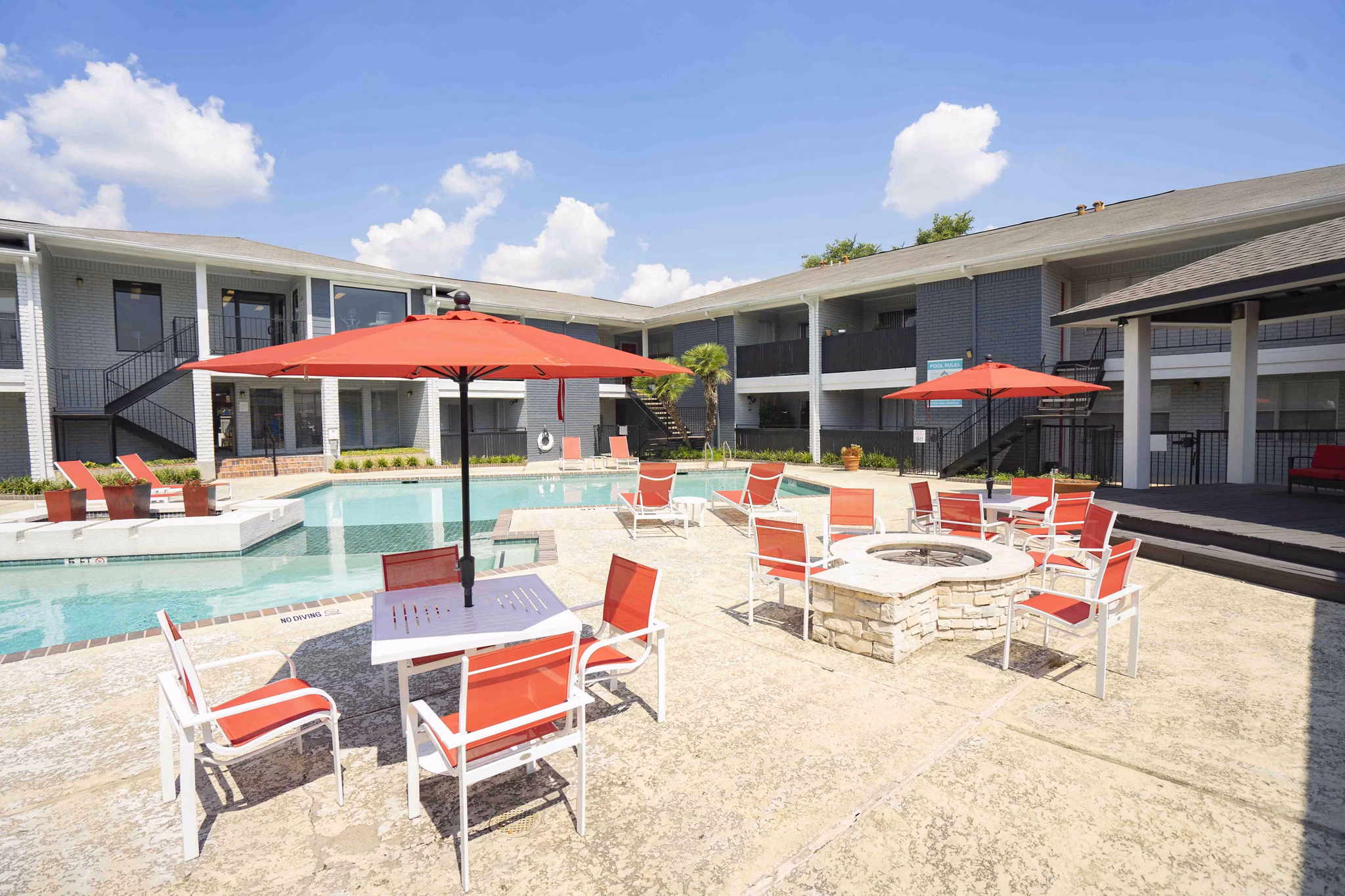 Fire pit lounge area with seating at 3 Corners East Apartments