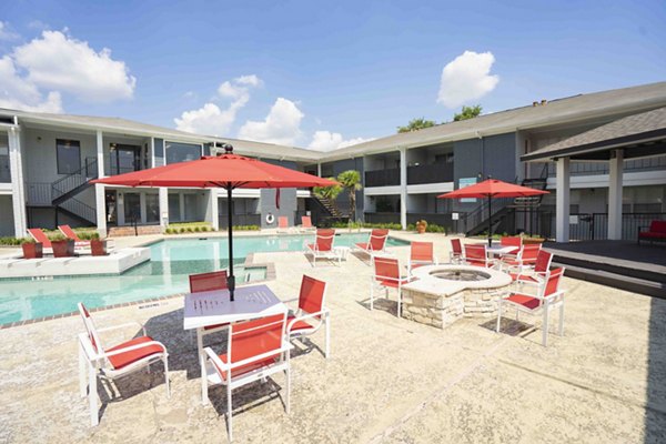 Fire pit lounge area with seating at 3 Corners East Apartments