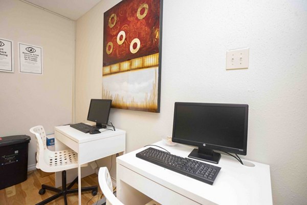Modern business center with computer stations at 3 Corners North Apartments, featuring collaborative workspaces