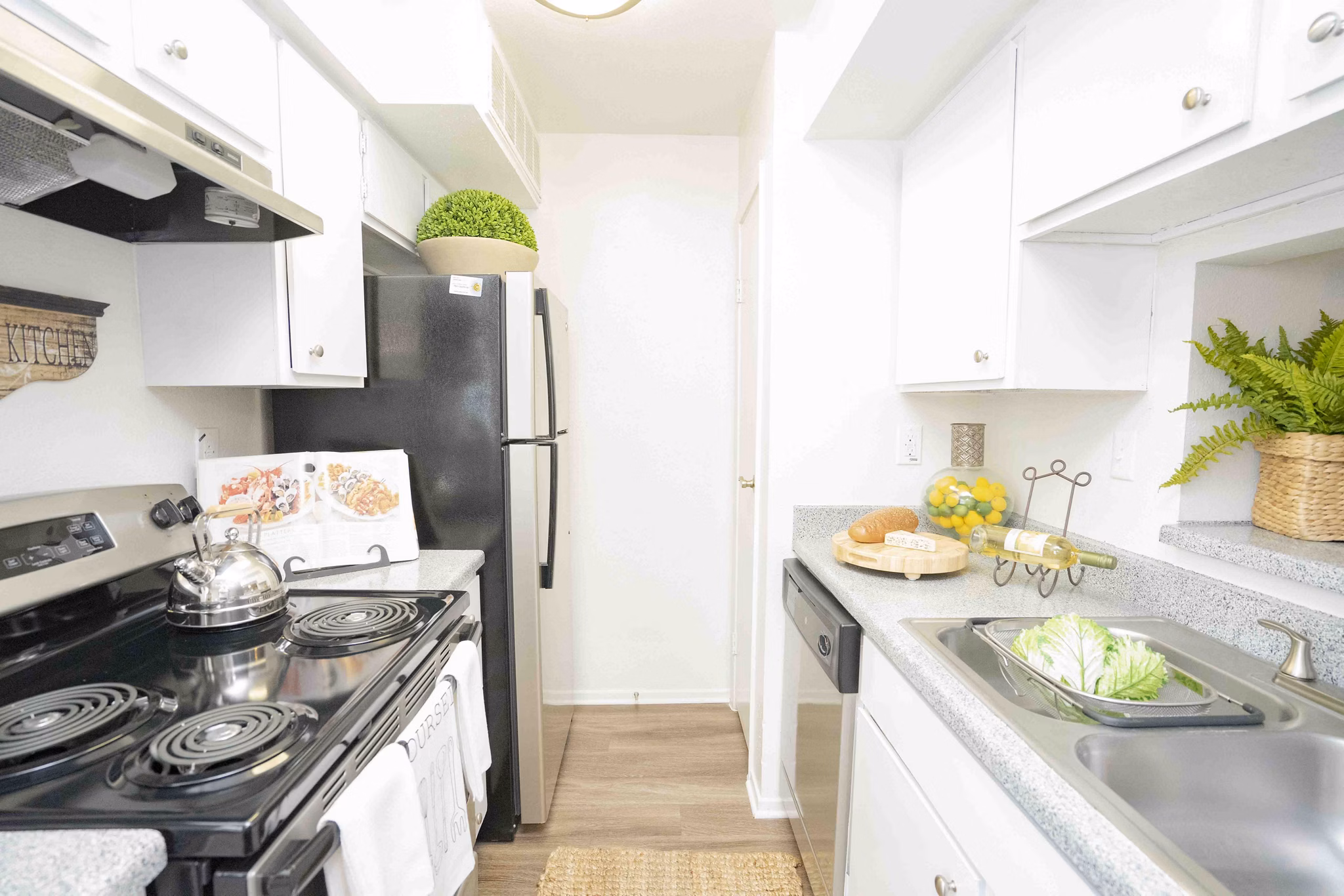 Kitchen featuring modern appliances and quartz countertops at 3 Corners North Apartments