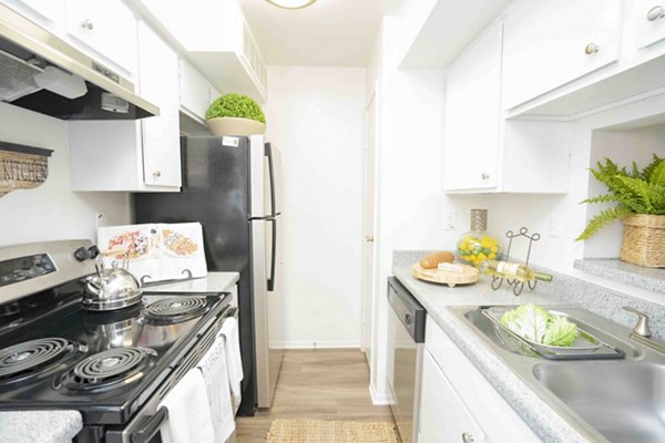 Kitchen featuring modern appliances and quartz countertops at 3 Corners North Apartments