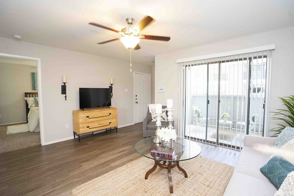 Living room with plush seating and modern decor at 3 Corners North Apartments, showcasing a luxurious and inviting space