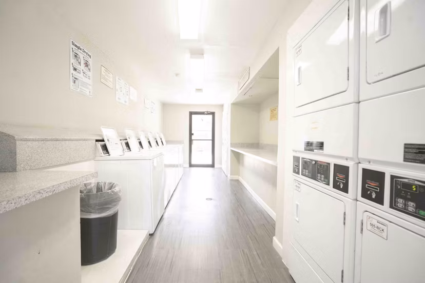Laundry facility at 3 Corners North Apartments offering modern machines and spacious folding area