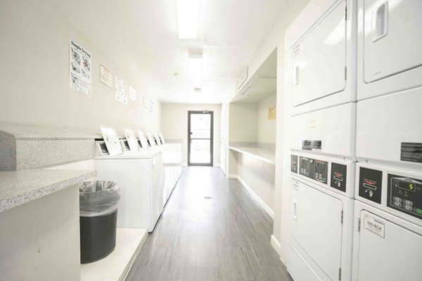 Laundry facility at 3 Corners North Apartments offering modern machines and spacious folding area