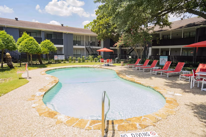 Sunlit outdoor pool at 3 Corners North Apartments, ideal for relaxation and socializing in a serene setting