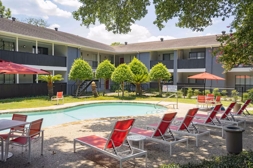 Resort-style pool with sun loungers at 3 Corners North Apartments, offering luxury amenities for relaxation and recreation