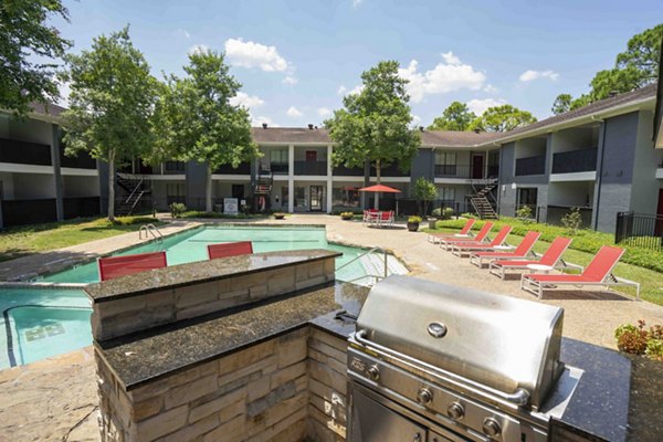 Modern grill area at 3 Corners North Apartments featuring sleek outdoor seating