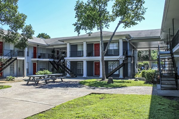 Courtyard featuring lush landscaping and seating areas at 3 Corners West Apartments