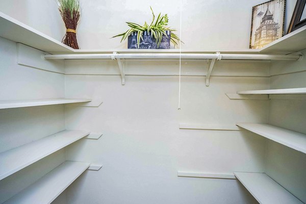 Spacious bedroom closet with built-in shelves in 3 Corners West Apartments, luxury living by Greystar