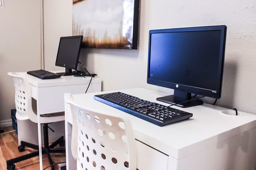 Modern business center featuring workstations and Wi-Fi at 3 Corners West Apartments