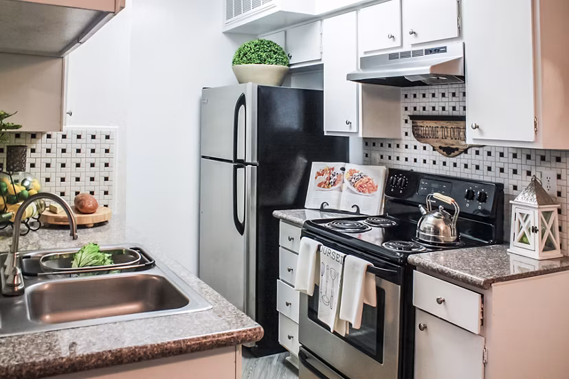 Modern kitchen with stainless steel appliances at 3 Corners West Apartments