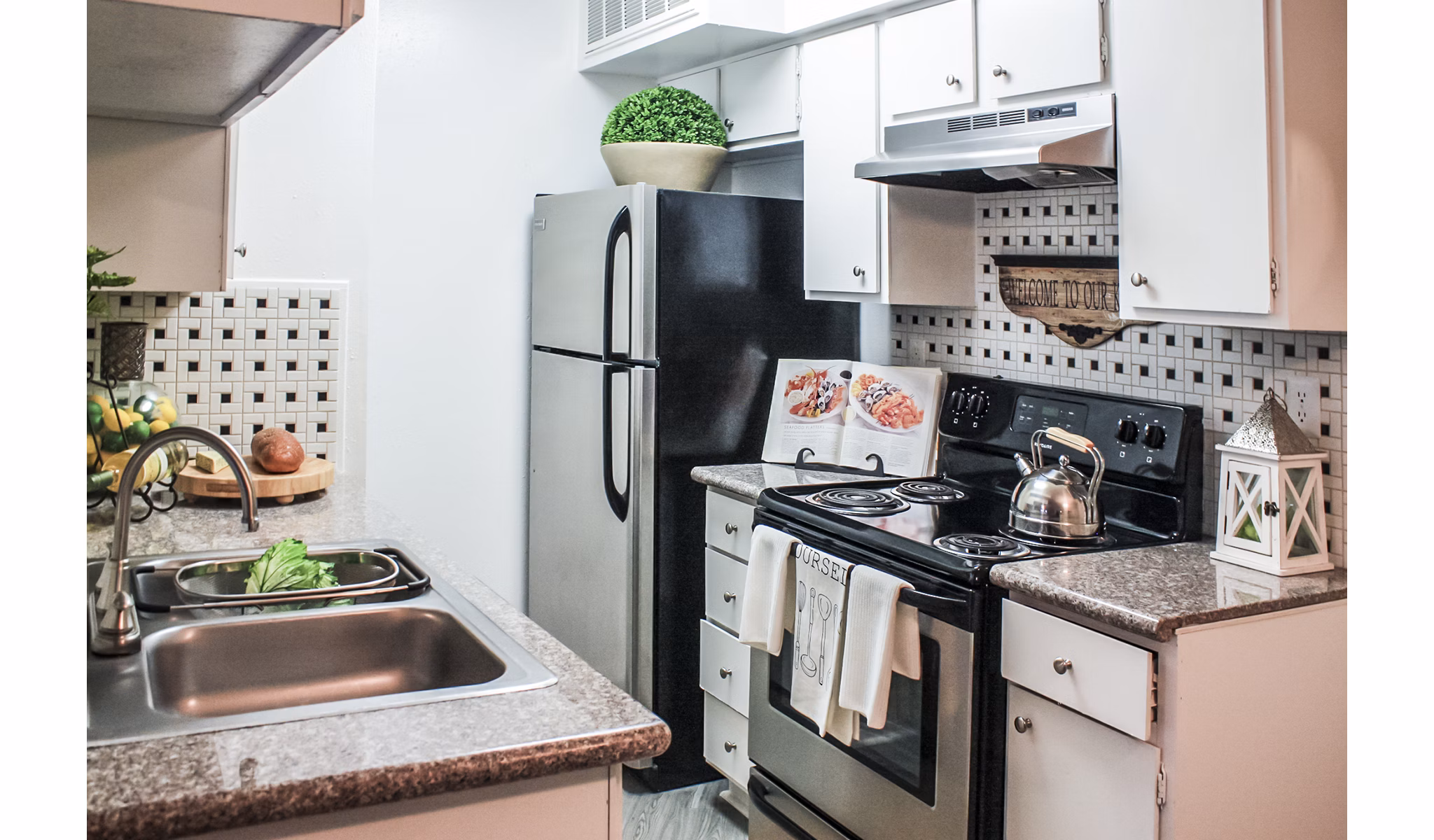 Modern kitchen with stainless steel appliances at 3 Corners West Apartments