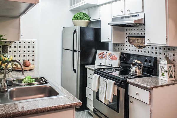 Modern kitchen with stainless steel appliances at 3 Corners West Apartments