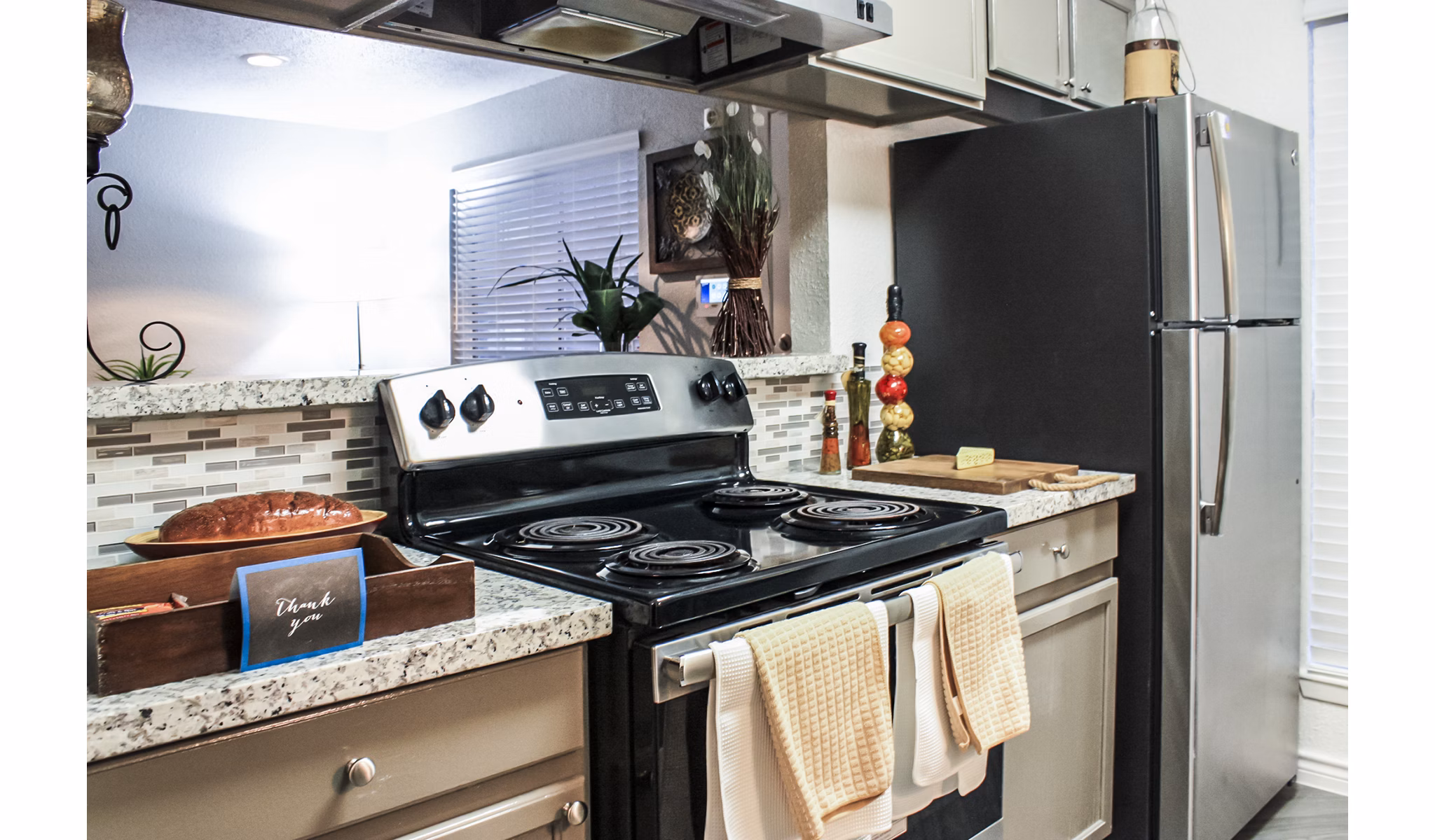 Modern kitchen with stainless steel appliances at 3 Corners West Apartments