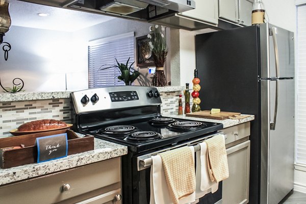 Modern kitchen with stainless steel appliances at 3 Corners West Apartments