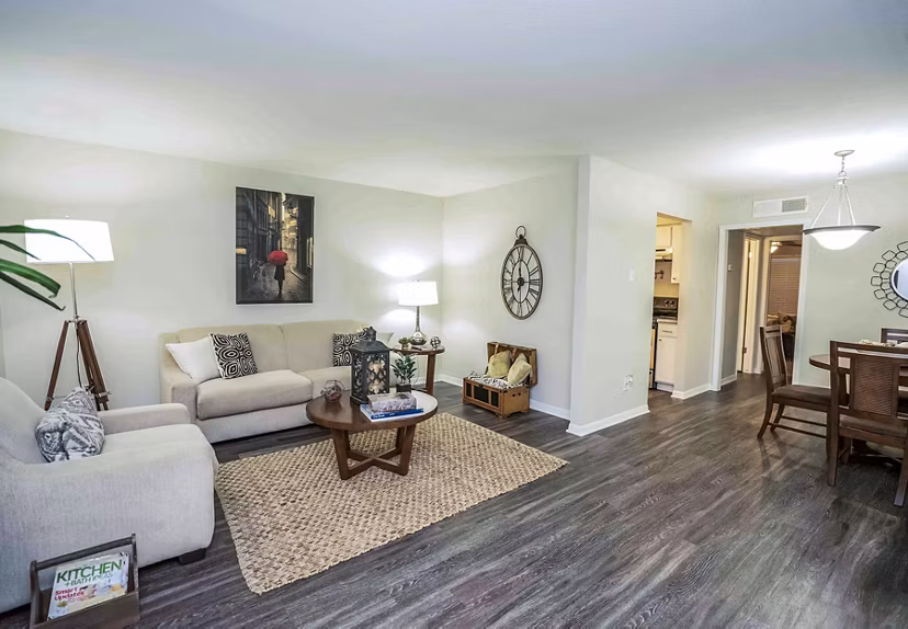 Spacious living room with modern furnishings at 3 Corners West Apartments in Greystar community