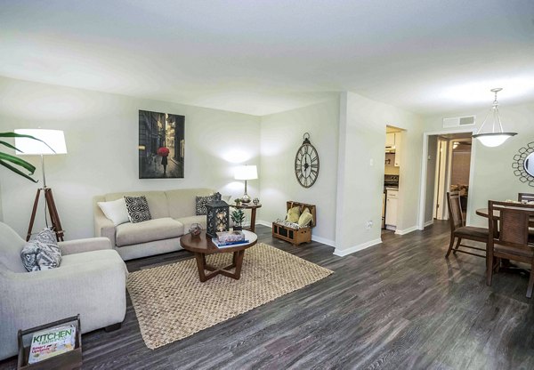 Spacious living room with modern furnishings at 3 Corners West Apartments in Greystar community